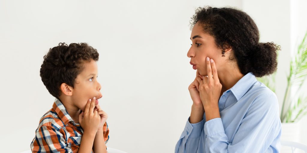 Speech pathologist guiding a child through speech sounds and articulation exercises
