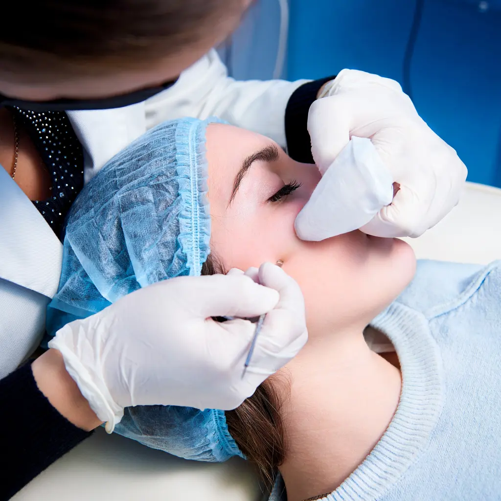 Clinician examining a patient’s facial skin during a skin check
